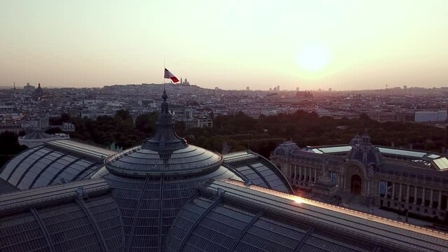 Aerial view from Grand Palais des Champs-Elysees (Great Palace, 1900) - historic site, exhibition hall and museum complex in Paris, France. refreshing view of Golden sunrise over Montmartre at horizon