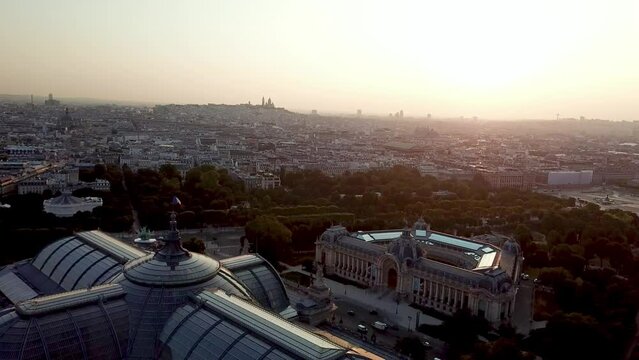 Mesmerising Aerial opening shot of Paris city featuring famous tourist destination, The Grand Palais and Petit palais with whole city covered with mist at sunrise over Montmartre 