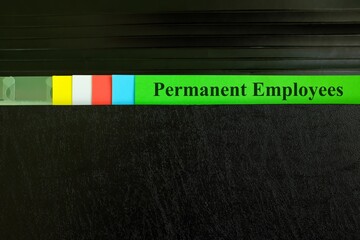 Permanent employees file record in black binder folder. Human resources concept.	