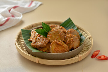 Rendang Jengkol, dogfruit simmered in spices and coconut milk. Indonesian traditional comfort food, with a spicy savory taste typical of rendang and a legit jengkol texture. Served on plate