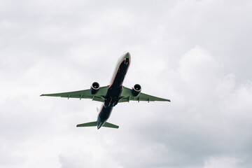Passenger plane comes in for landing in cloudy weather.