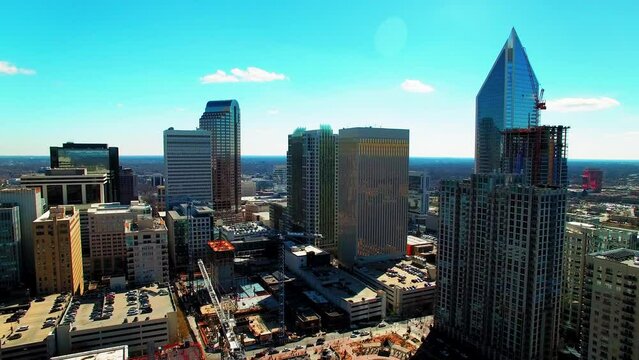 Aerial Panning Shot Of Modern Skyscrapers With Cars Moving On Roads During Sunny Day - Charlotte, North Carolina