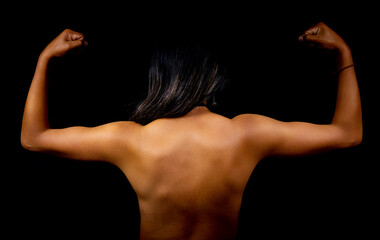 Fototapeta na wymiar latin woman from behind with bare skin showing muscles on a black background