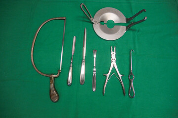 various instruments for an amputation lie on a surgical cloth