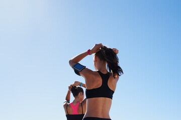 Fitness women, blue sky background and hair tie for cardio exercise, running workout and summer...