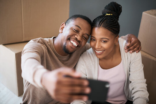 Phone, couple and selfie while moving in to home, real estate or apartment, happy and proud on a floor. New house, property and man with woman on a living floor for picture, moment and bonding
