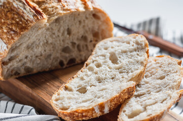 Fresh sliced bread for breakfast on a cutting board.