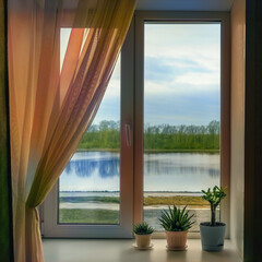 Fototapeta na wymiar The window in the room with houseplants on window sill and curtains against the backdrop of the river and forest during in the rain. 