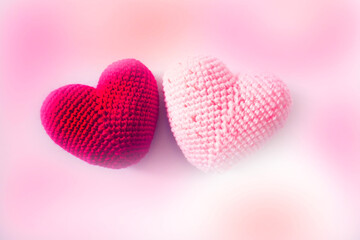 Obraz premium Pink and red crochet hearts and soft pink background. Love , romance, wedding, boho style
