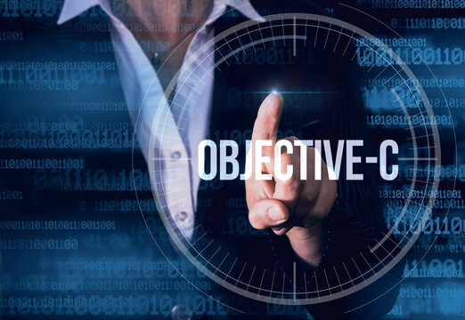Business Woman with finger pressing Objective-C button on virtual screens. Modern technology concept
