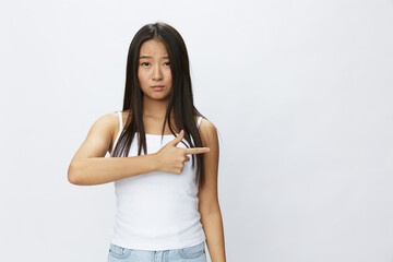 Asian woman hand signals, finger pointing facial skin problems, acne and inflammation, red rash and...