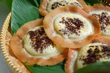 traditional pancake named serabi in a woven plate 