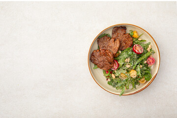 Portion of gourmet salad with roast beef