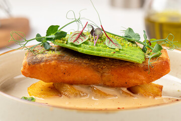Portion of gourmet dish with trout and avocado