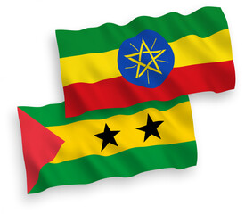 National vector fabric wave flags of Saint Thomas and Prince and Ethiopia isolated on white background. 1 to 2 proportion.