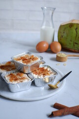 homemade coconut custard cake topped with almond slices and cinnamon 