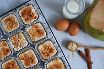 baked coconut custard cake or klappertaart with almond slices toppings 