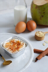 baked coconut custard cake or klappertaart with almond slices toppings 