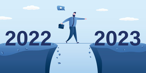 Obraz premium Year 2023 hope, new year resolution or success opportunity, overcome business difficulty, ambitious businessman walks tightrope over an abyss from 2022 to 2023 year
