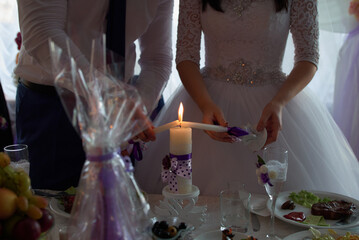 Wedding couple lighting a candle