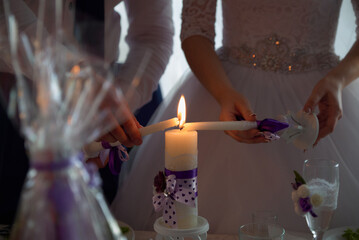 Wedding couple lighting a candle