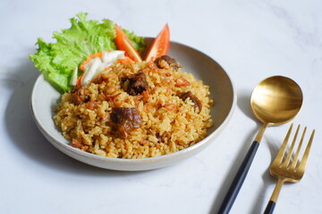 a plate of fried rice with meat 
