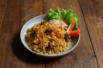 a plate of fried rice with meat 