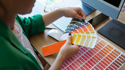 Female interior designer working with fan of colourful samples