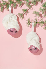 Christmas creative layout with two pink christmas baubles and towel turban wraps on pastel pink...