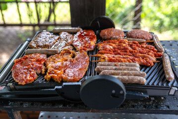 Delicious beef and pork meat, sausages on BBQ grill. Top view.