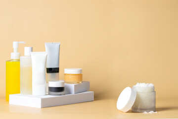 Fototapeta na wymiar Skincare routine and exfoliante step, salt scrub glass jar on beige background.