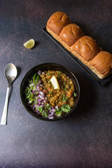Popular street food of Mumbai pav bhaji served in bowl.