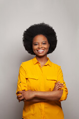 Obraz na płótnie Canvas Friendly cheerful attractive african american young 25s woman smiling pleasant having fun enjoying, standing hands crossed on white
