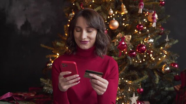 woman make purchase online using smartphone and credit card buy New Year gifts