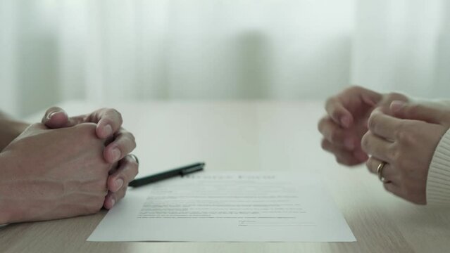 Husband and wife remove married ring between waiting sign divorce document. lovers have family problem, quarrel, conflict, illness, financial problems, violence, infidelity, personal habit, impairment