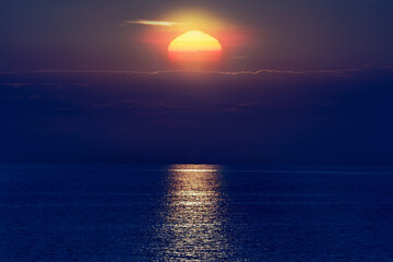 Tropical sunset sunrise over the ocean sea horizon.