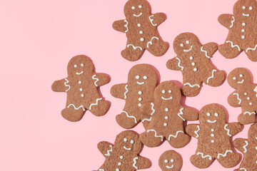 Christmas creative layout with gingerbread man cookies on pastel pink background. 80s or 90s retro...