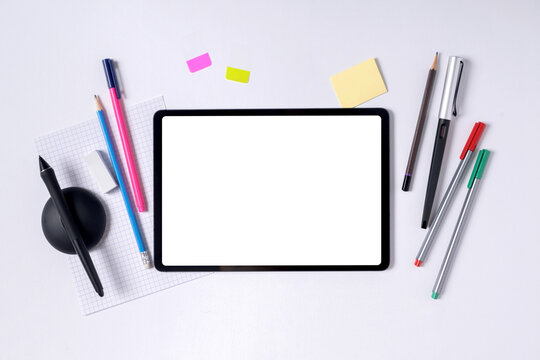 A tablet and stationery set for creators on the desk (blank screen and blank space)