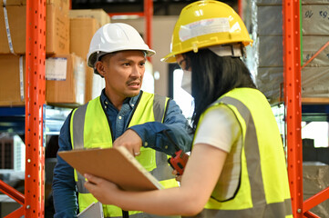 Angry and mad Asian male warehouse supervisor complained to his female worker