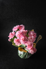 small pink carnations on black background