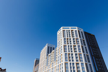 Fototapeta premium A new high-rise building against the blue sky. 