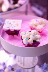 Bright mouth-watering sweets on a colored table during the holiday