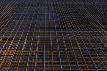 Steel wire mesh piles. BRC welded wire mesh for the construction of floor slabs, supporting frame of a building or monolithic panel. in natural light view from above. Selective focus. pouring concrete