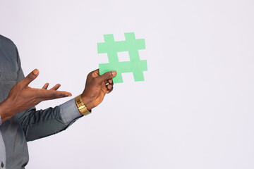 african businessman holding a hash tag symbol