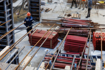 Construction workers are busy with their work. Construction of a residential house in the summertime. The concept of a construction site. 