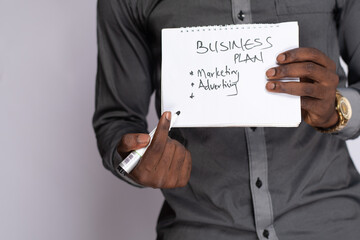 african businessman holding a business plan