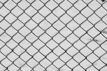 Fototapeta premium Metal mesh with a layer of ice on it during freezing rain in winter, frostbite and environment, weather