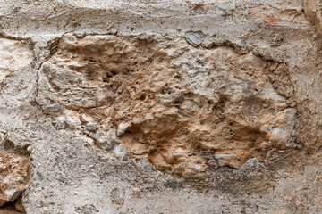 Surface of beige sandy rock. Durable building material and archaeological site. Background. Space for text.