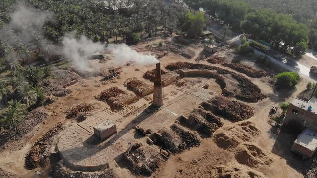Aerial shot of smoky chimney burning stubble at farm in Khairpur Sindh.