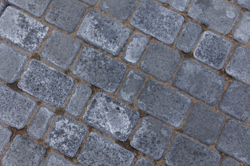 Paving tile texture on the bottom of the street. stone floor background. Concrete sidewalk tiles. 
Modern textured sidewalk tile square and rectangular flooring in the works. tile and sand. 